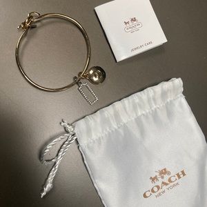 Gold tone Coach bracelet with bag